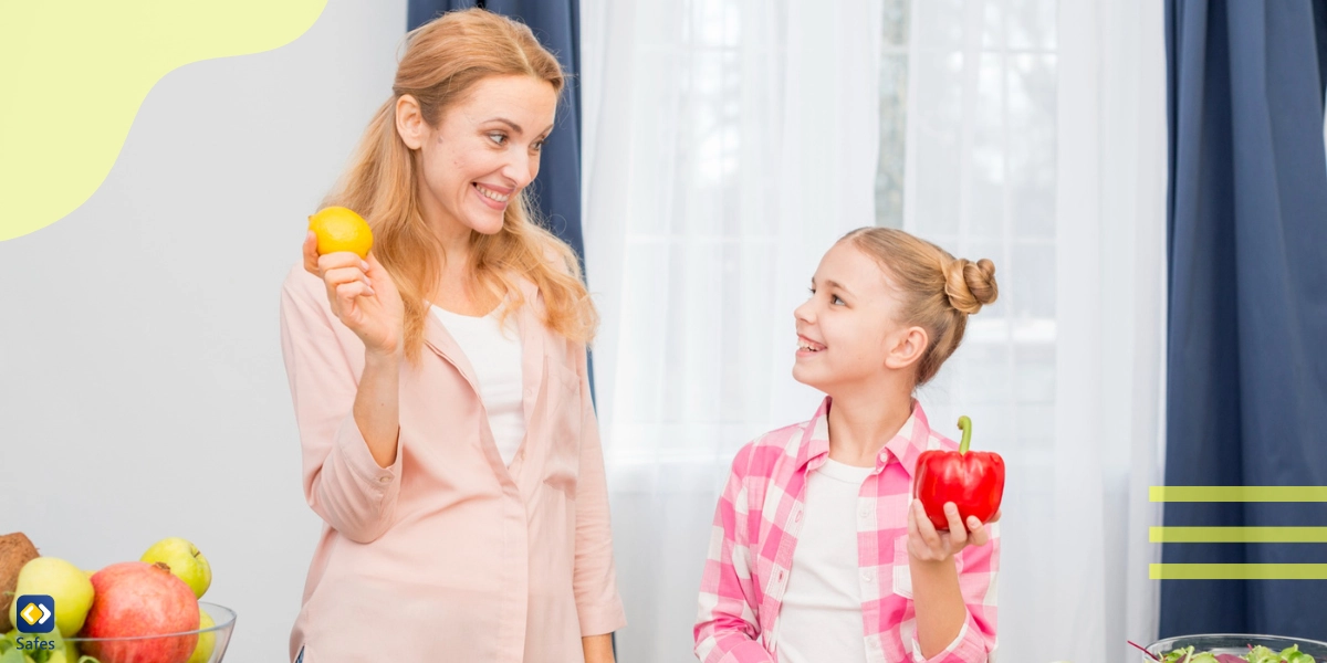 Eine Mutter und ihre Tochter kochen glücklich mit Gemüse